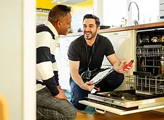 Technician talking with a customer about their dishwasher