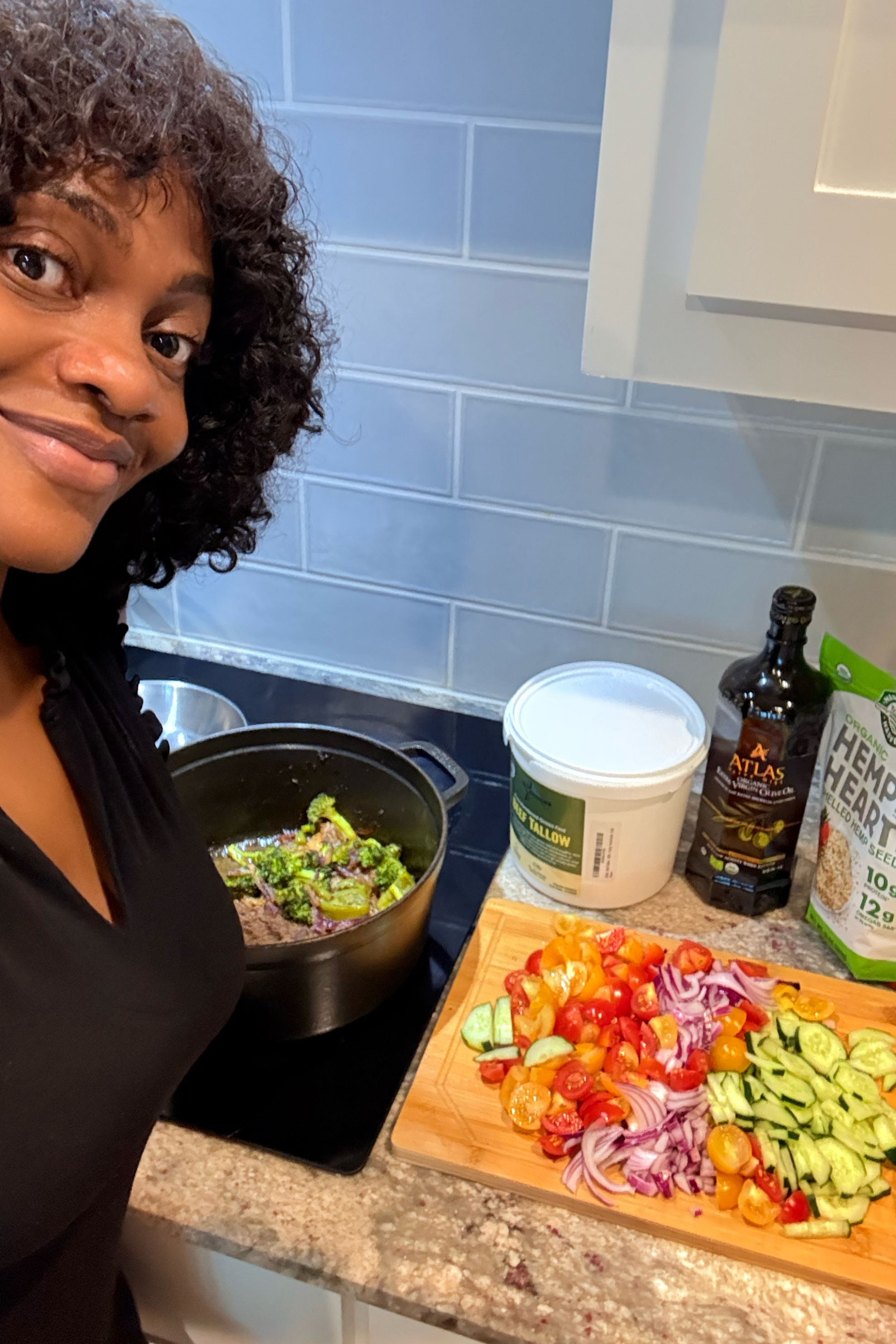 Smiling woman preparing healthy vegetables in a kitchen