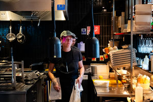 Chef working in a busy restaurant kitchen.