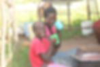 Smiling woman and child drinking from colourful cups outdoors