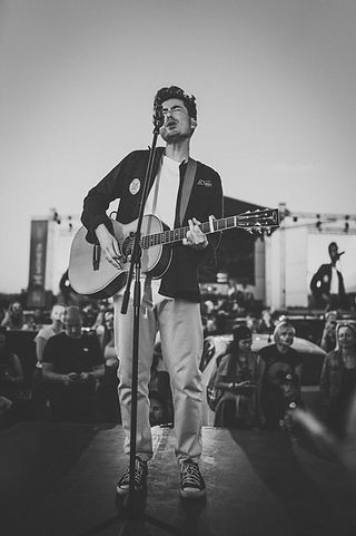 musician singing in front of a crowd