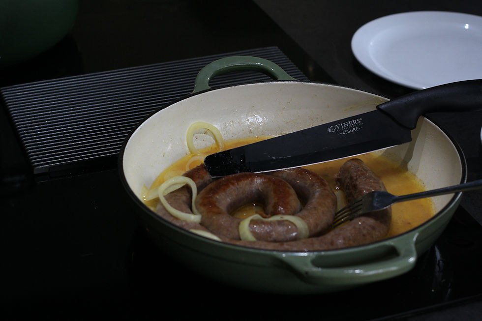 Boerewors simmering in onion sauce as part of the South African starter cooked in class