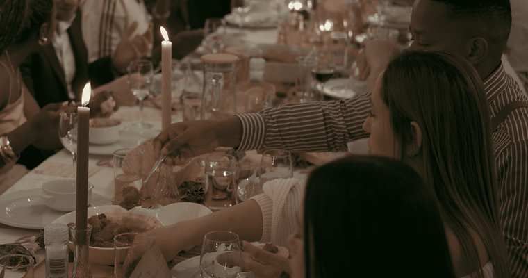 Group enjoying a curated long‑table dining experience celebrating heritage, storytelling, and shared dishes.