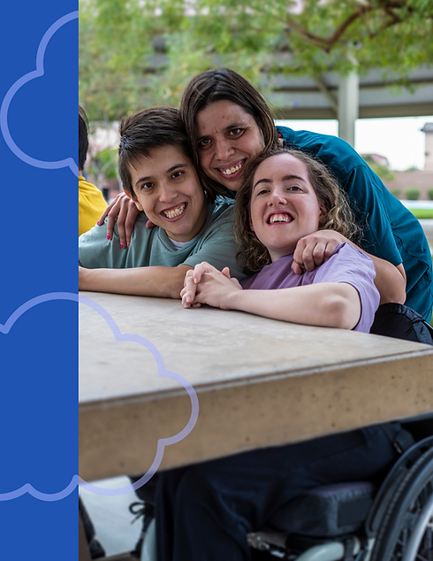 Three people gathered together smiling at the camera for a photo