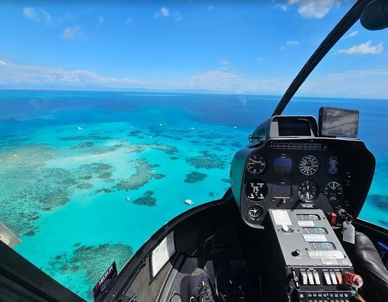 Tourists enjoying a scenic helicopter flight over the Great Barrier Reef.