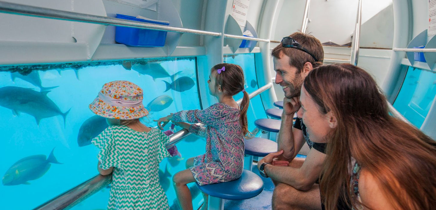 Tourist paddleboarding in clear blue lagoon at the reef.