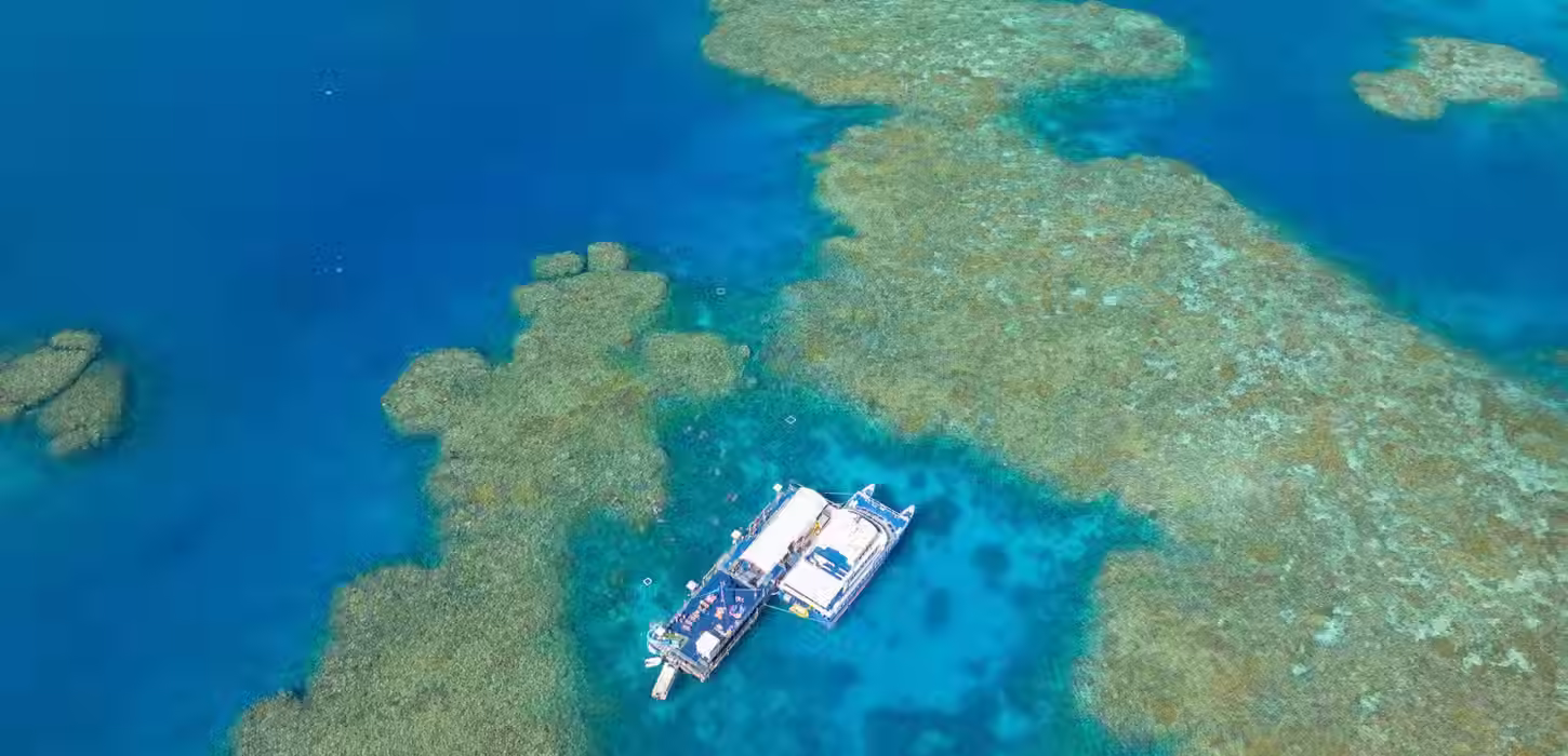 Aerial view of coral reef and turquoise ocean at the Great Barrier Reef, Australia.