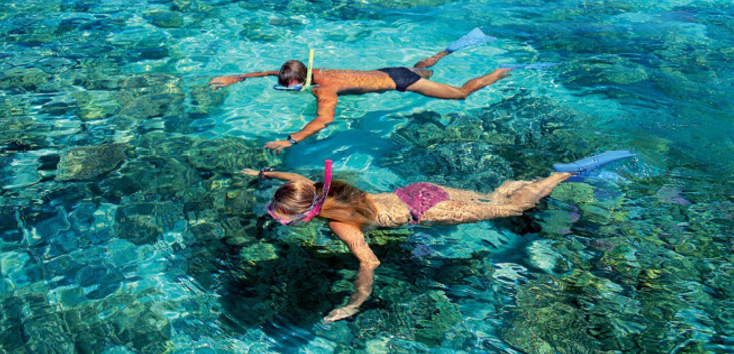 Tourists enjoying a scenic helicopter flight over the Great Barrier Reef.