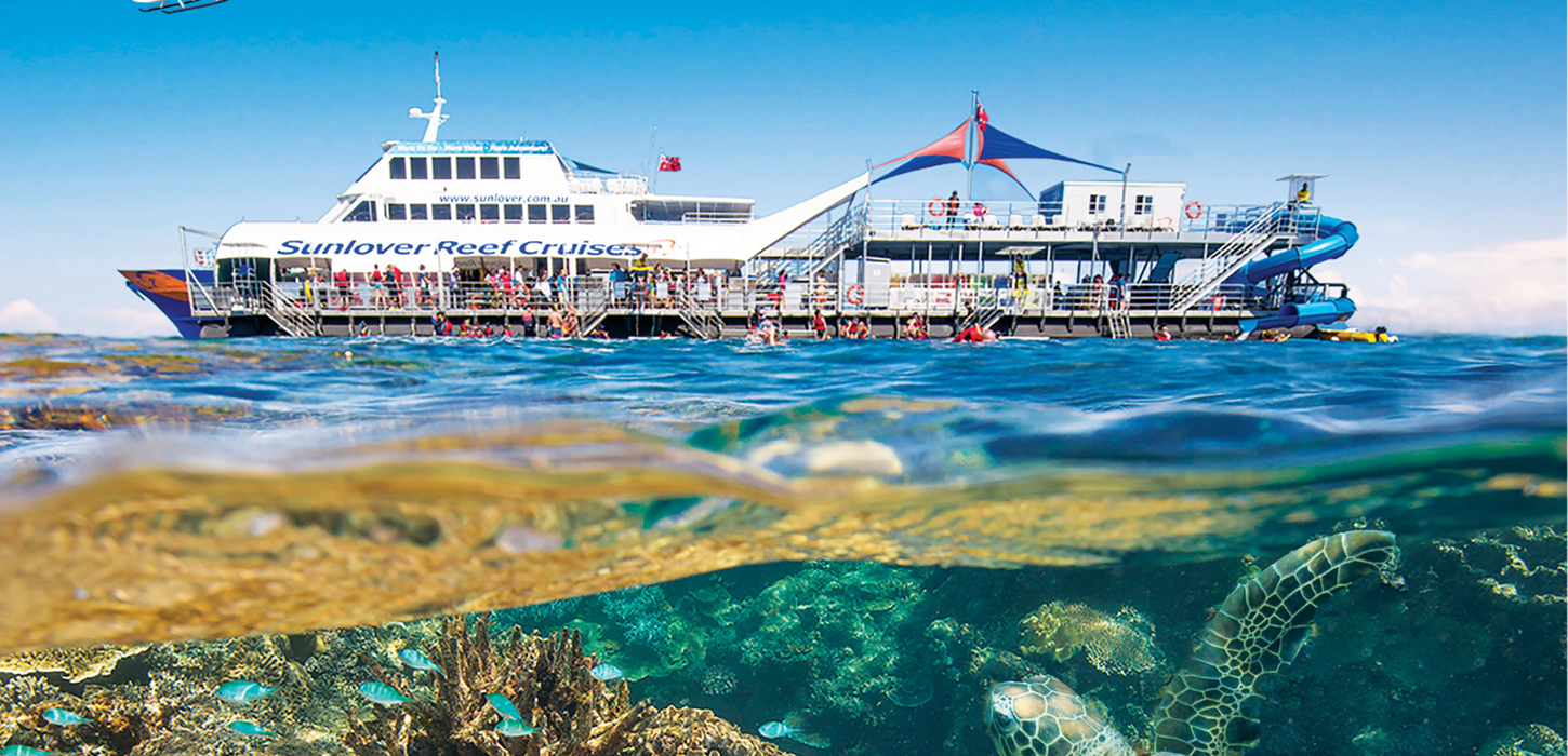 Aerial view of coral reef and turquoise ocean at the Great Barrier Reef, Australia.