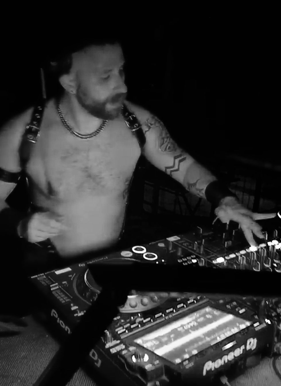 DJ Skippo playing a techno set in fetish gear