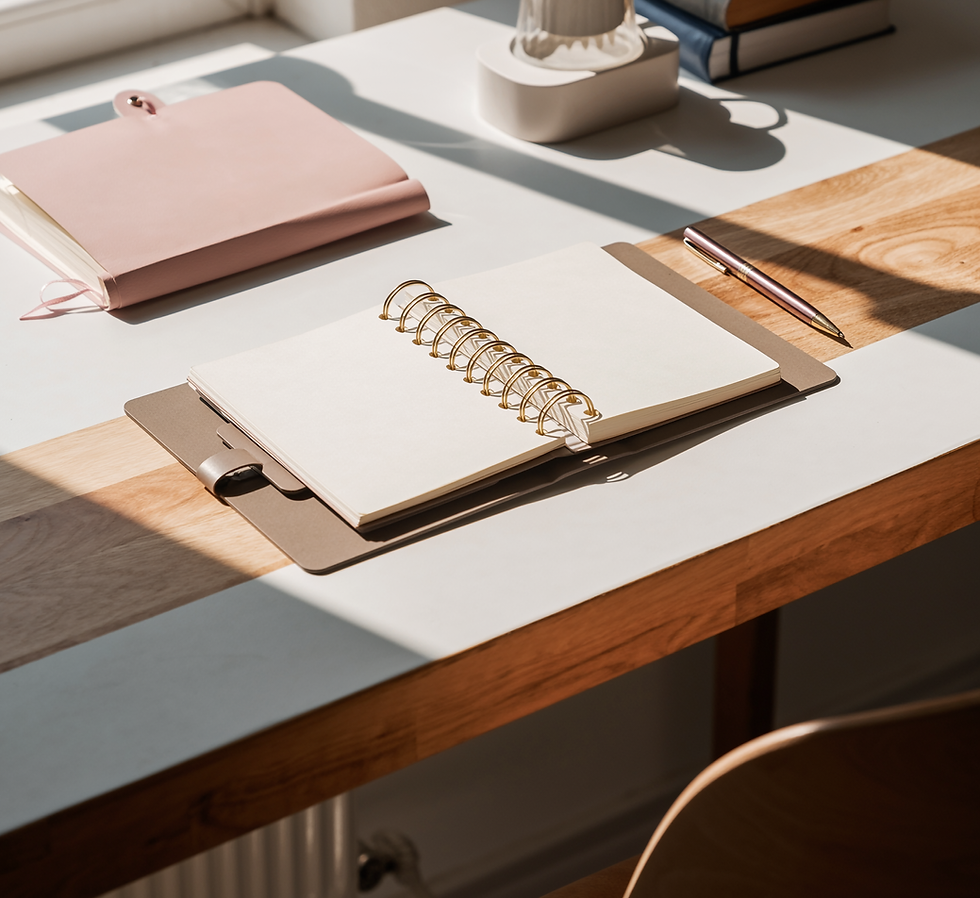 Open notebook and pen on a desk.