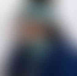 Female model wearing wool knitted headband and snood in grey, green and coral