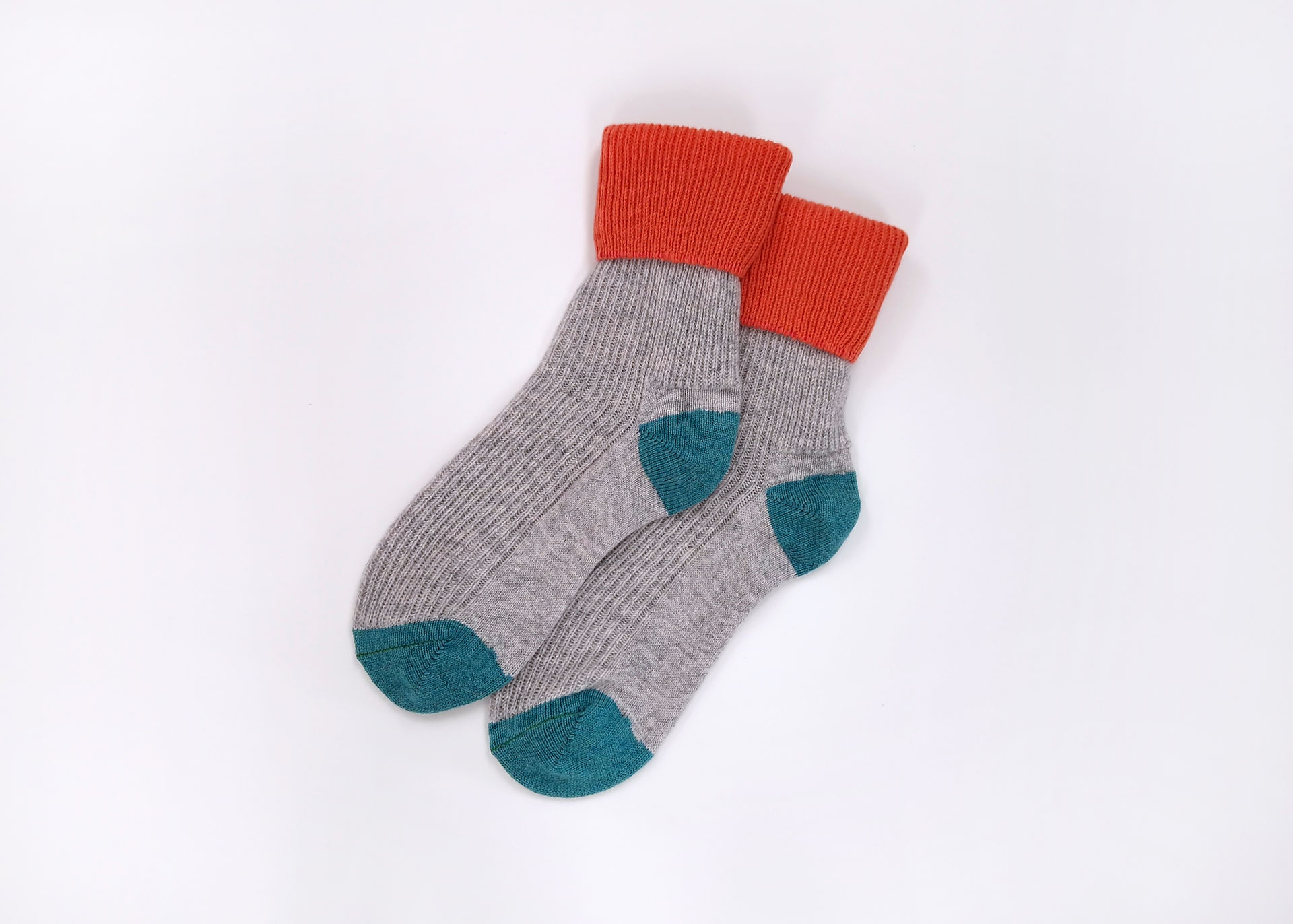 A pair of grey, green and coral knitted wool socks
