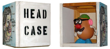 HEAD CASE
A wall hanging open box made of joined canvases. Frontal is a painting, right side text, left side is the inside view into the case. Photographed from 3 angels.
1997,Mixed media on canvas
10 x 8 x 8 inches