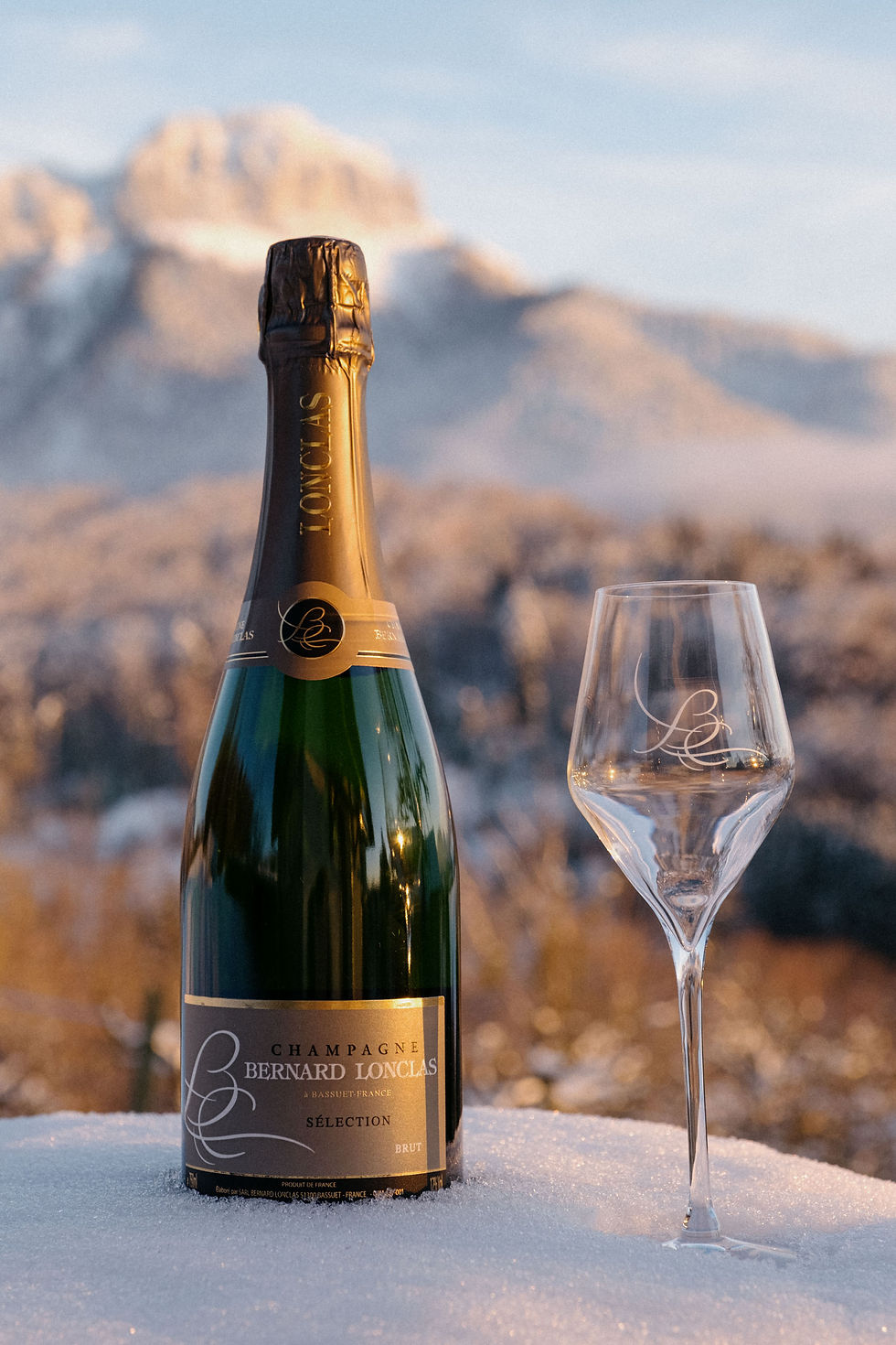 Bottle and glass of Bernard Lonclas champagne in the mountains