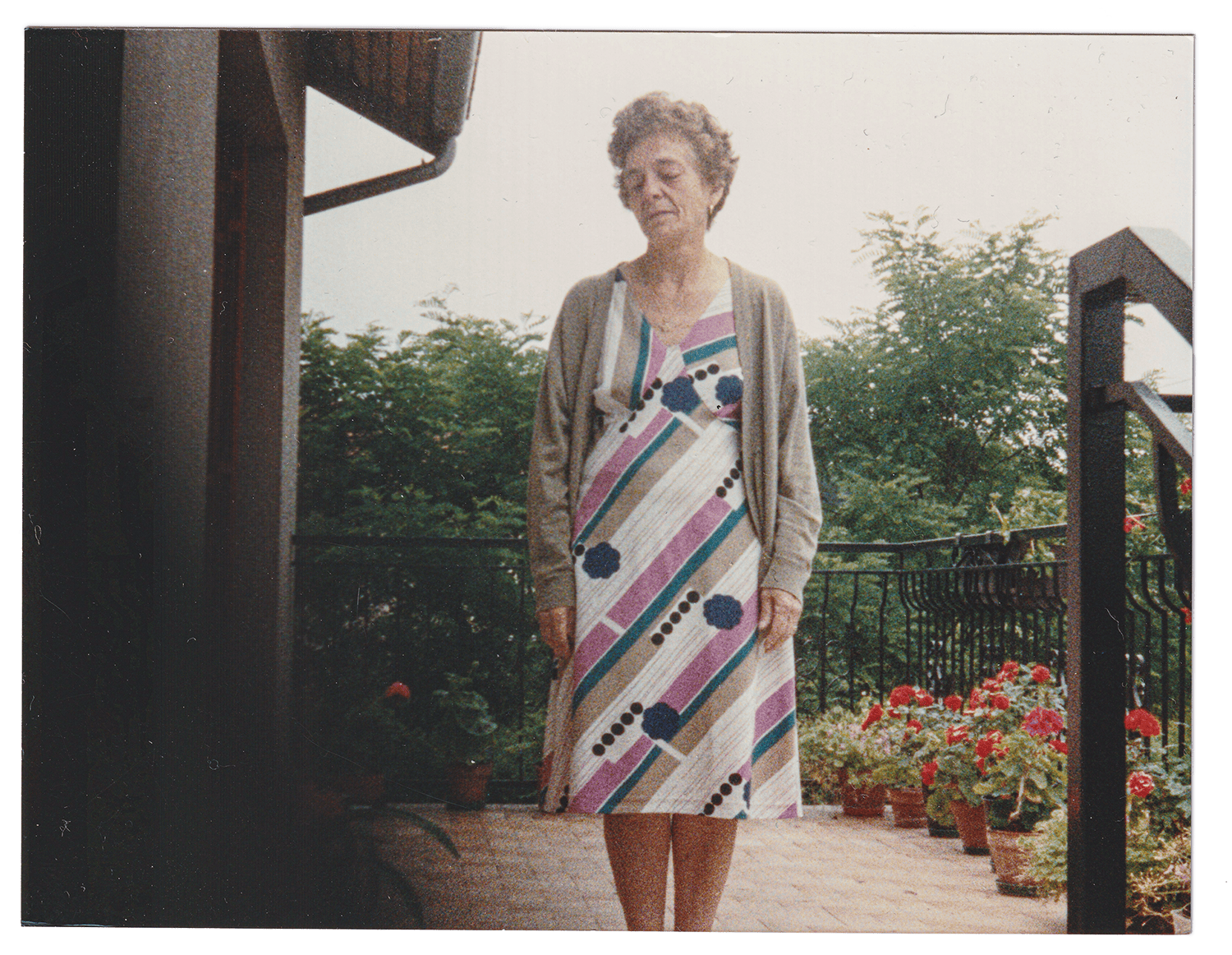 An elderly woman on a flowery balcony, the scent of jasmine.
