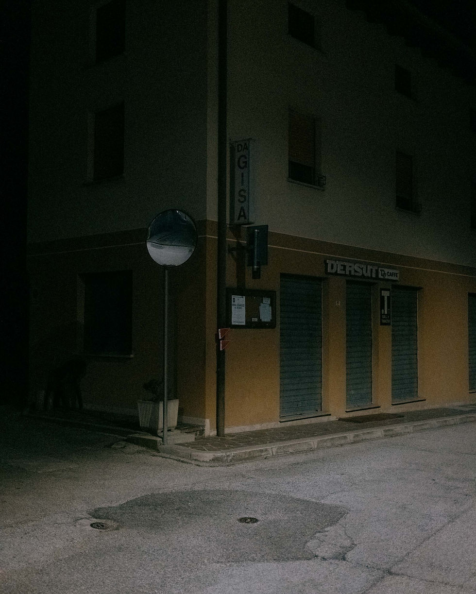 The dark facade of a building at night evokes the scent of jasmine.