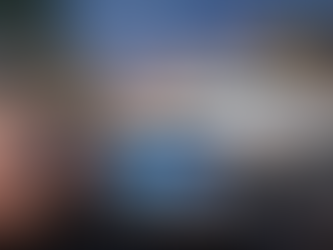 Car key programming device and key fob in Downtown Delray Beach with vehicle in background during twilight