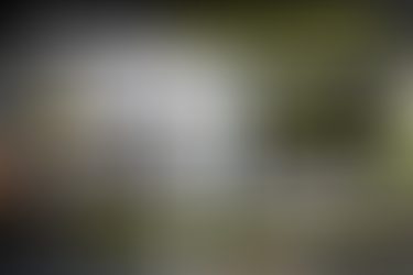 Technician installing a residential deadbolt lock on a door near Woolbright Road in Boynton Beach with black gray and neon yellow themed locksmith graphic