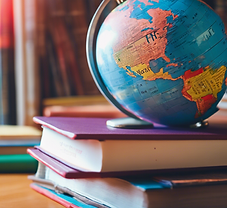 Globe sitting atop stack of books