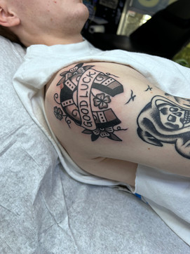 Good Luck Horseshoe Rose American Traditional Tattoo Trad Tattoo Black and Grey by Erik Jeffrey. Death Proof Tattoo and Barber. Whistler, BC. Pemberton, Squamish, Vancouver Canada. Tattoo Studio. Tattoo Shop. Barber Shop. Tattoo Artist. Professional Services.