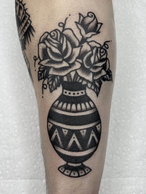 Rose Vase Flower American Traditional Tattoo Trad Tattoo Black and Grey by Erik Jeffrey. Death Proof Tattoo and Barber. Whistler, BC. Pemberton, Squamish, Vancouver Canada. Tattoo Studio. Tattoo Shop. Barber Shop. Tattoo Artist. Professional Services.