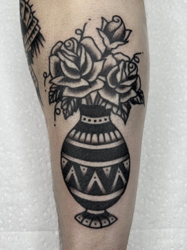 Rose Vase Flower American Traditional Tattoo Trad Tattoo Black and Grey by Erik Jeffrey. Death Proof Tattoo and Barber. Whistler, BC. Pemberton, Squamish, Vancouver Canada. Tattoo Studio. Tattoo Shop. Barber Shop. Tattoo Artist. Professional Services.