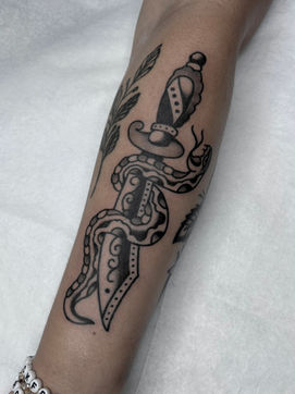 Snake Dagger Forearm Arm American Traditional Tattoo Trad Tattoo Black and Grey by Erik Jeffrey. Death Proof Tattoo and Barber.  Whistler, BC. Pemberton, Squamish, Vancouver Canada. Tattoo Studio. Tattoo Shop. Barber Shop. Tattoo Artist. Professional Services.  