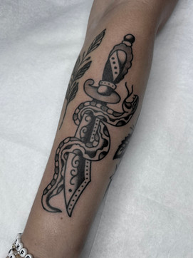 Snake Dagger Forearm Arm American Traditional Tattoo Trad Tattoo Black and Grey by Erik Jeffrey. Death Proof Tattoo and Barber. Whistler, BC. Pemberton, Squamish, Vancouver Canada. Tattoo Studio. Tattoo Shop. Barber Shop. Tattoo Artist. Professional Services.