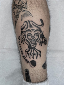Panther Ball and Chain American Traditional Tattoo Trad Tattoo Black and Grey by Erik Jeffrey. Death Proof Tattoo and Barber. Whistler, BC. Pemberton, Squamish, Vancouver Canada. Tattoo Studio. Tattoo Shop. Barber Shop. Tattoo Artist. Professional Services.