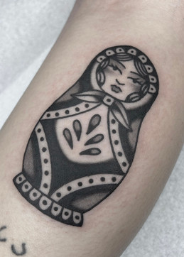 Russian Nesting Doll American Traditional Tattoo Trad Tattoo Black and Grey by Erik Jeffrey. Death Proof Tattoo and Barber. Whistler, BC. Pemberton, Squamish, Vancouver Canada. Tattoo Studio. Tattoo Shop. Barber Shop. Tattoo Artist. Professional Services.