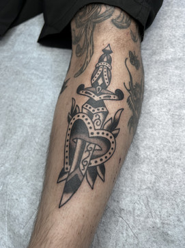 Heart RoseDagger American Traditional Tattoo Trad Tattoo Black and Grey by Erik Jeffrey. Death Proof Tattoo and Barber. Whistler, BC. Pemberton, Squamish, Vancouver Canada. Tattoo Studio. Tattoo Shop. Barber Shop. Tattoo Artist. Professional Services.