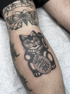 Lucky Cat American Traditional Tattoo Trad Tattoo Black and Grey by Erik Jeffrey. Death Proof Tattoo and Barber.  Whistler, BC. Pemberton, Squamish, Vancouver Canada. Tattoo Studio. Tattoo Shop. Barber Shop. Tattoo Artist. Professional Services.  