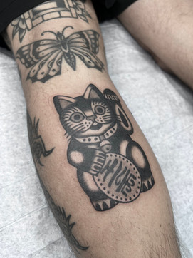 Lucky Cat American Traditional Tattoo Trad Tattoo Black and Grey by Erik Jeffrey. Death Proof Tattoo and Barber. Whistler, BC. Pemberton, Squamish, Vancouver Canada. Tattoo Studio. Tattoo Shop. Barber Shop. Tattoo Artist. Professional Services.