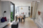 An open plan kitchen and living area is light filled, with views to the side courtyard, containing Petersen D91 bricks.