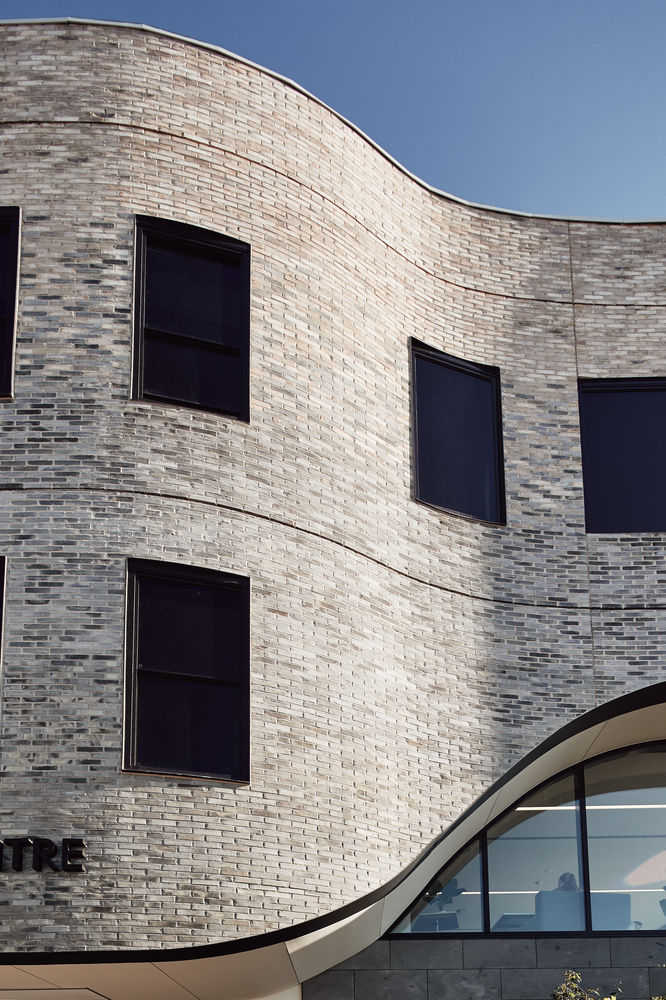 A curved veil of Petersen bricks reflects the innovation in MLC’s new