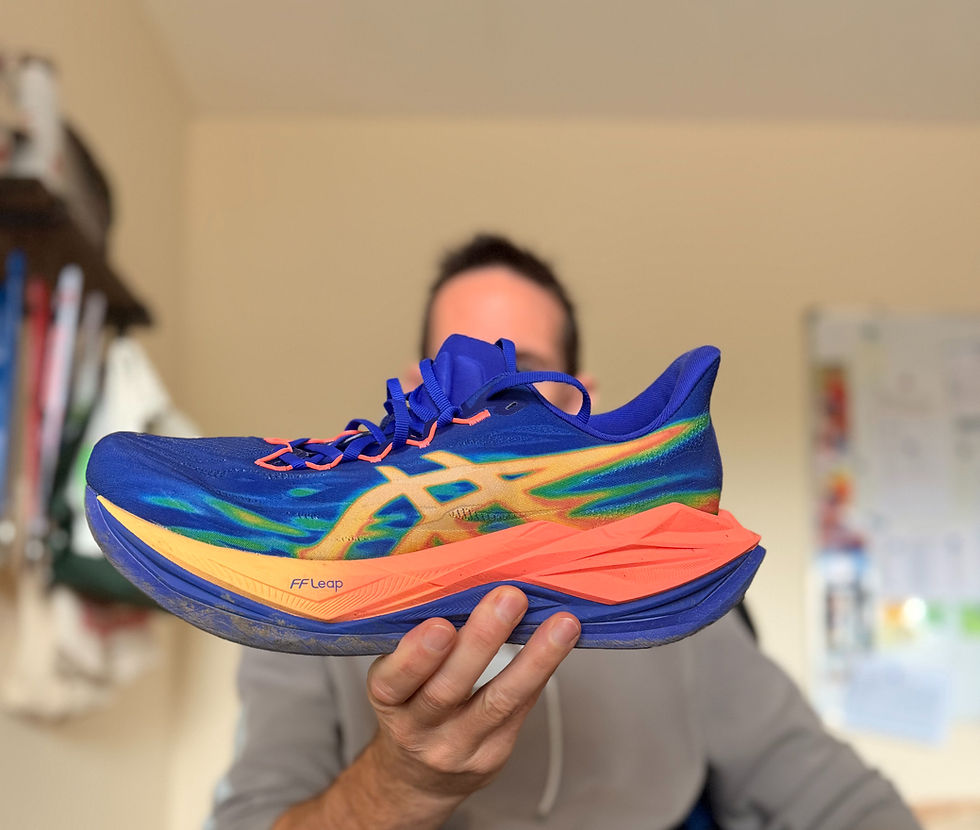 man holding ascis superblast 3 running shoe