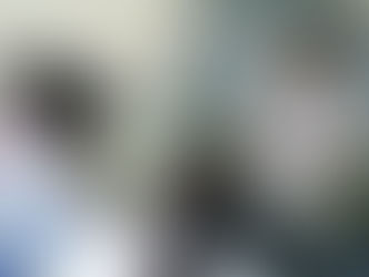 A new TEFL teacher standing in front of a class, gesturing while giving instructions to students. This illustrates the common mistake of not grading language effectively during "Teacher Talk."