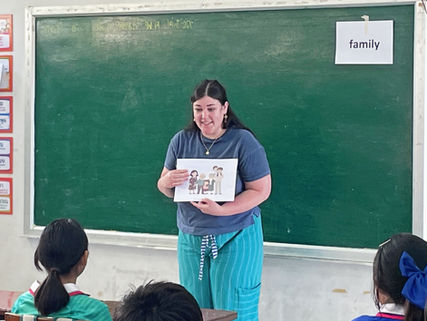 Trinity CertTESOL graduate Hannah teaching students in a classroom in Thailand