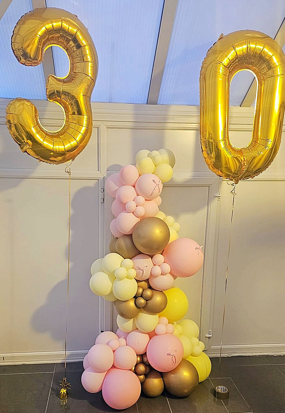 30th birthday grab and go balloon garland in blush and buttercup