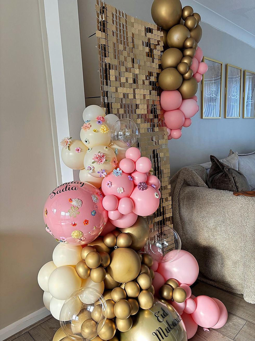 Gold shimmer wall with pink and gold organic balloon garland for birthday party