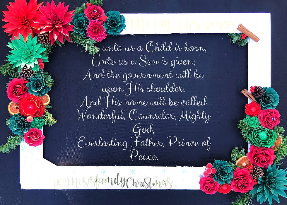 A Christmas selfie frame made using paper flowers in Christmas red and green. I also embellished with dried orange slices, red berries and scented cinnamon sticks.