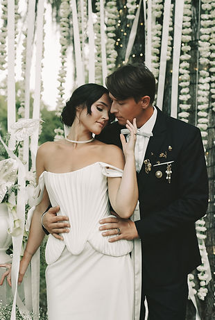 A bride and groom stand together under a tree at the 1616 House in Montgomery, AL.