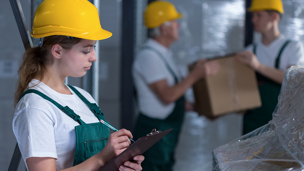 Factory workers operating machinery in a manufacturing facility.