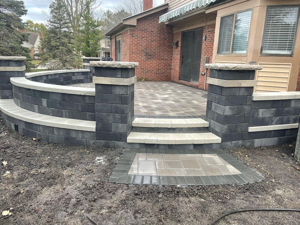 Custom backyard patio with brick work and brick railing
