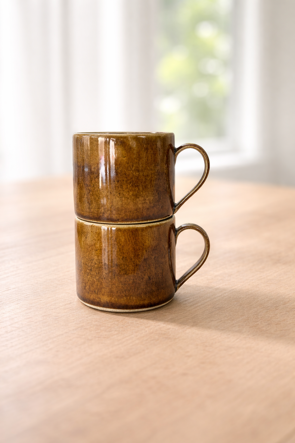 stacked and close up sunstone handmade ceramic mug with warm golden tones and a glossy finish