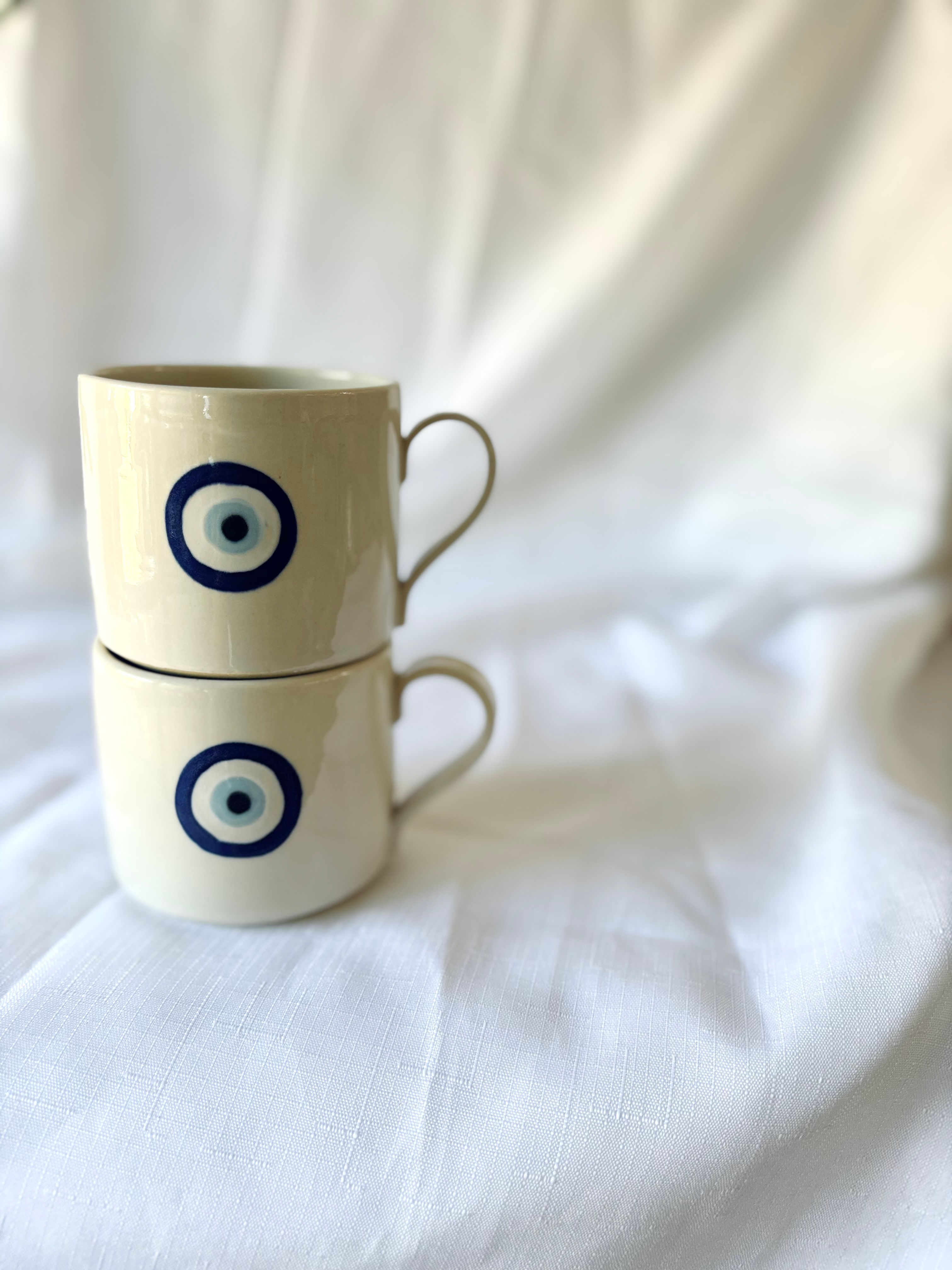 Greek evil eye mati mug in blues and whites with rounded comfortable handle