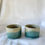 Thumbnail: Ranges handmade tumbler pair set in muted greens and speckled grey side by side