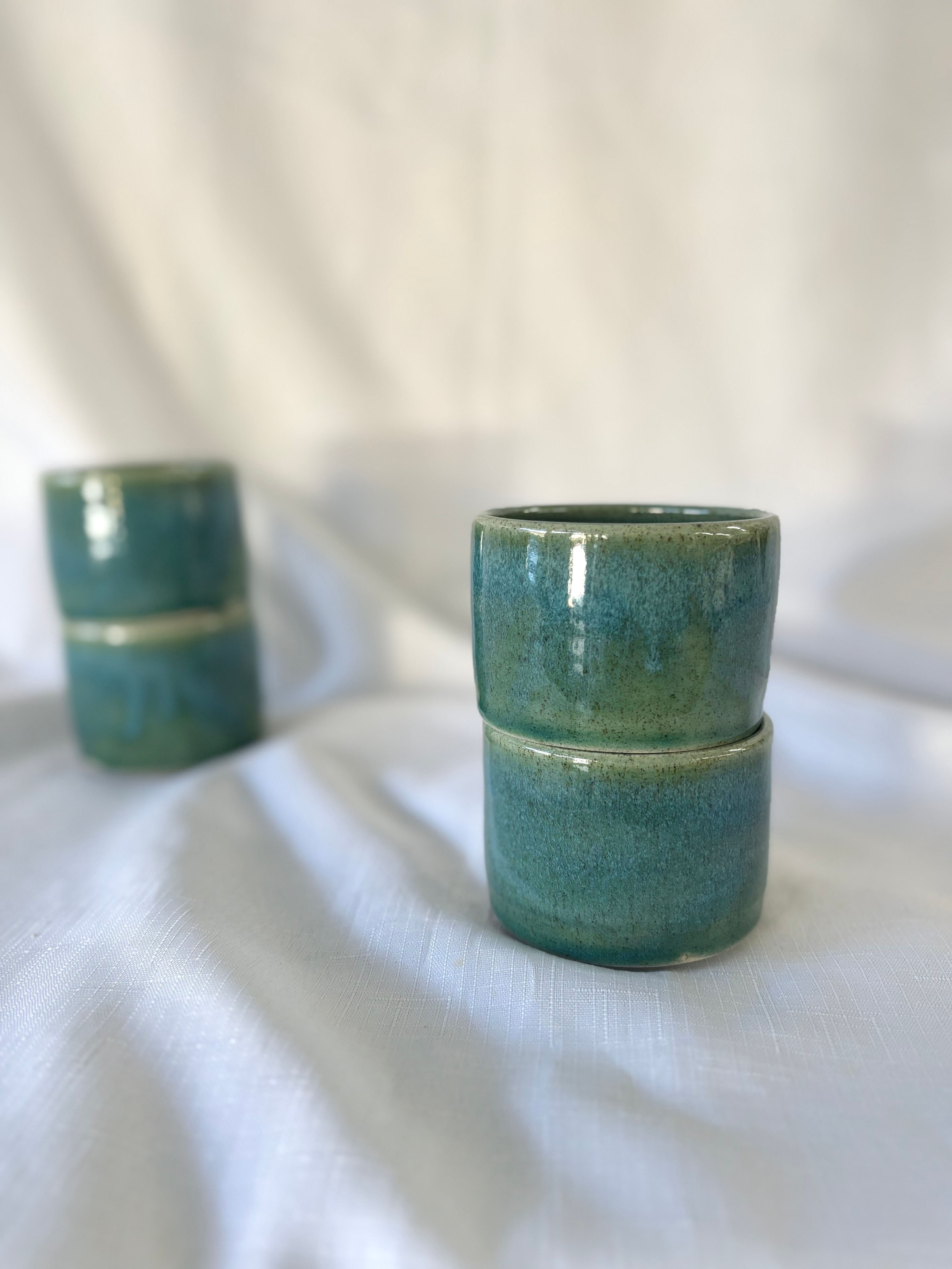 Stacked Close-up of deep green Kuitpo handmade tumbler pair glazed with subtle flecks