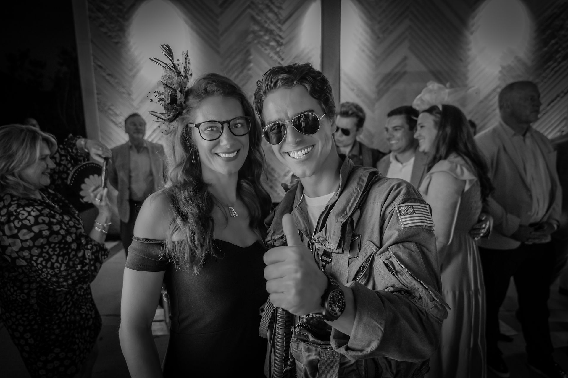 Smiling couple at party; man in Maverick costume